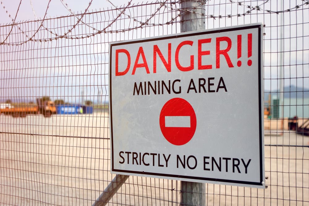 Warning: Restricted Access – Hazardous Mining Site. Unauthorized entry strictly prohibited.